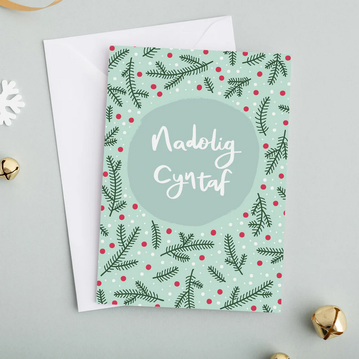 Welsh First Christmas card 'Nadolig Cyntaf' foliage and berries